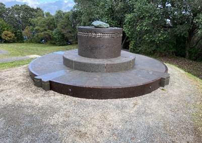 A circular stone monument with a chain around it

Description automatically generated