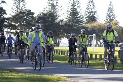 A group of people riding bicycles

Description automatically generated