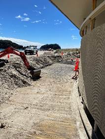 A construction site with a bulldozer and a truck

Description automatically generated
