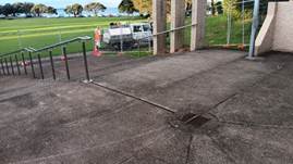 A concrete walkway with railings

Description automatically generated