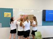 A group of girls in a classroom

Description automatically generated