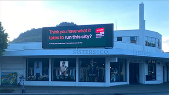 A store front with a sign

Description automatically generated